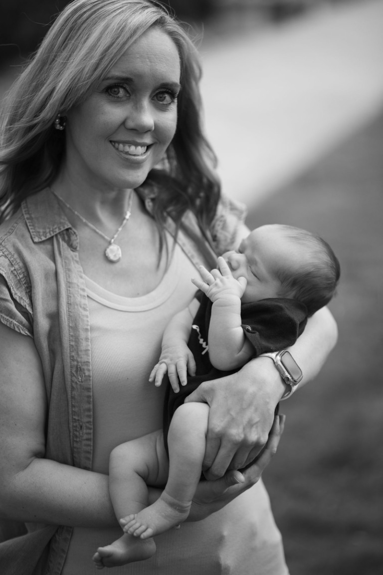 A mother gently holding her newborn baby