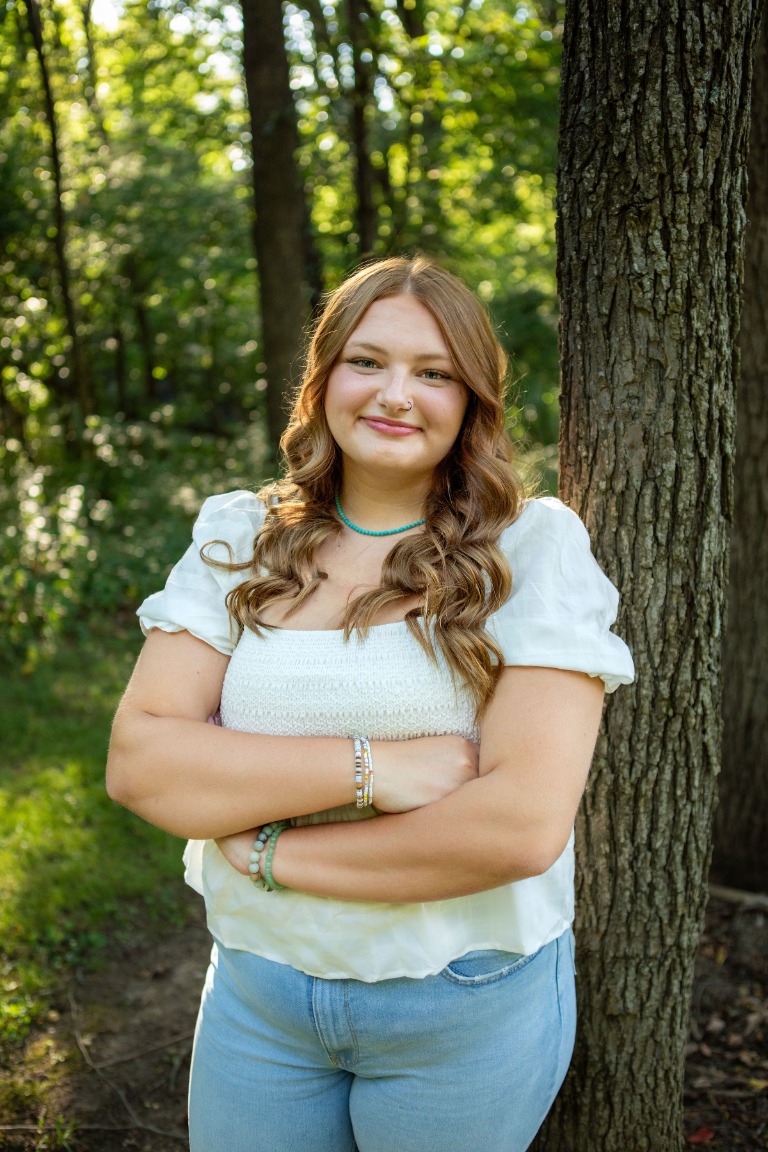 A senior portrait among the trees